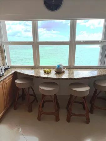 a kitchen with a table chairs and a window