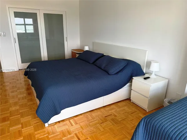 a bedroom with a bed and a mirror