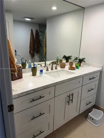 a bathroom with double sink and a mirror