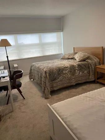 a bedroom with a bed and a chair in it