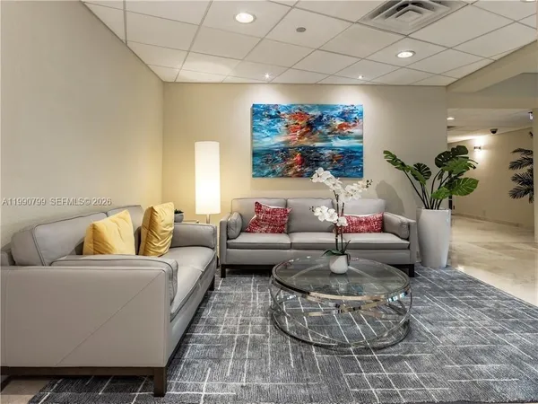 a living room with furniture and a potted plant
