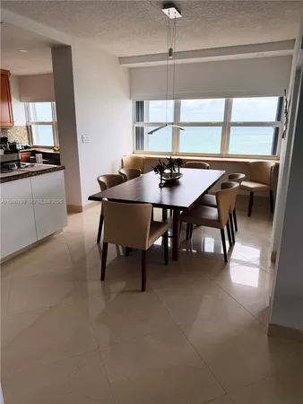 a view of a dining room with furniture and window