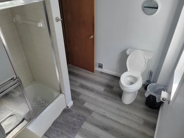 a view of front door with wooden floor