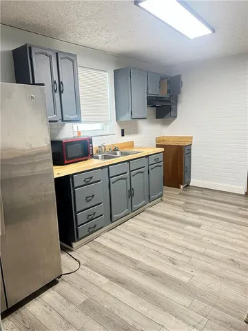 a kitchen with stainless steel appliances granite countertop a sink a stove and a refrigerator