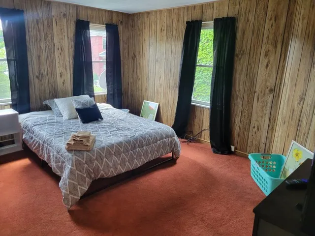 a bedroom with a bed and window