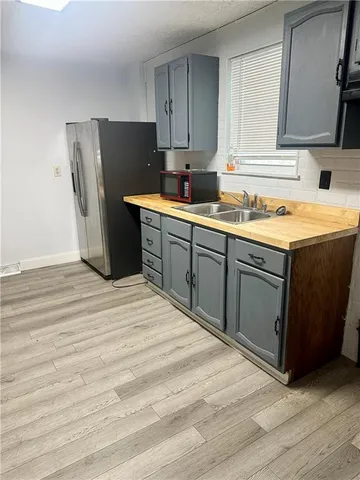 a kitchen with stainless steel appliances granite countertop a refrigerator stove top oven and sink