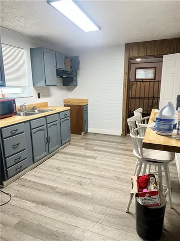 a kitchen with stainless steel appliances kitchen island granite countertop a sink dishwasher stove and cabinets