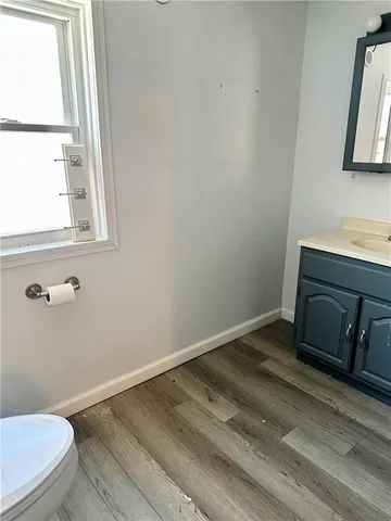 a bathroom with a sink a toilet and a window