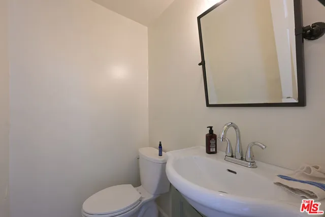a white toilet sitting next to a bathroom sink