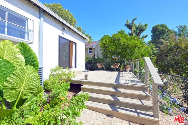 a view of a chairs and table in patio