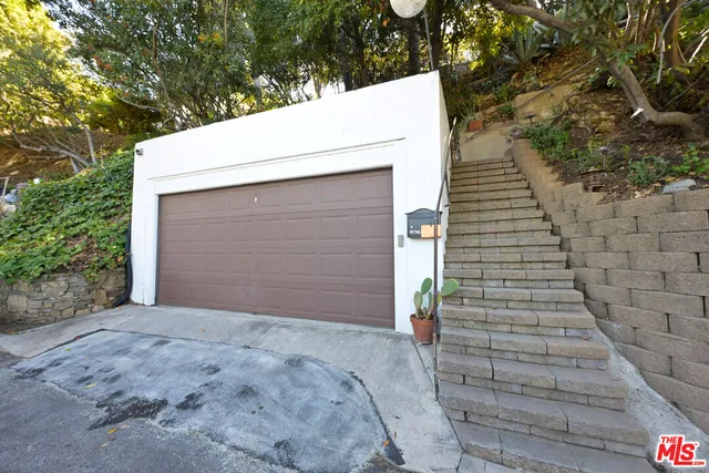 front view of a house with a yard and garden