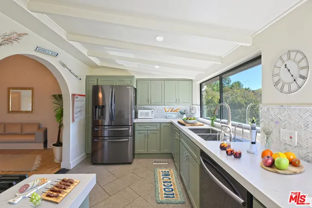 a kitchen with a refrigerator and a sink