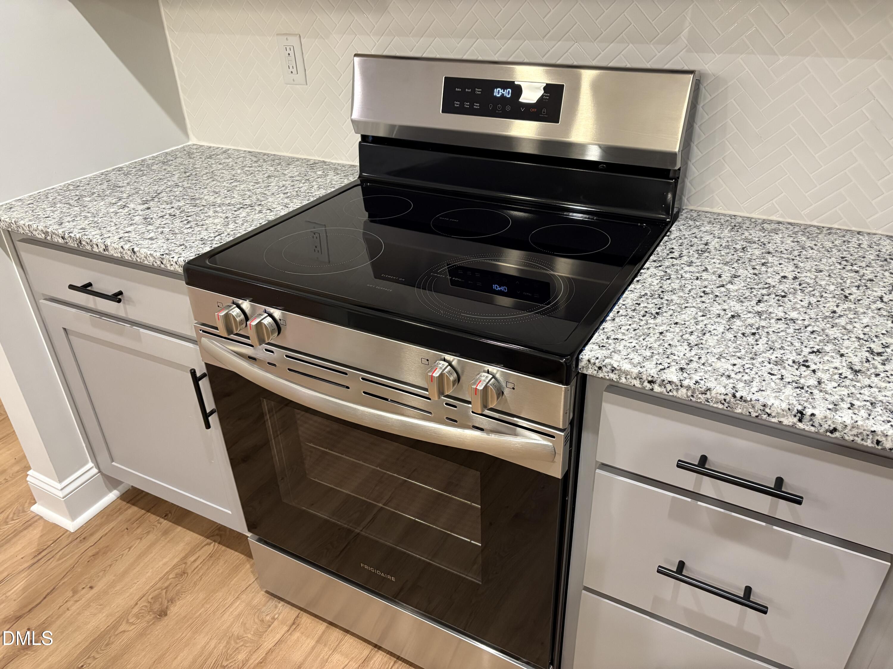 607 Weather Ridge Lane, Unit 24 Cary, NC 27513 - Photo 10 of 26 a stove top oven sitting inside of a kitchen