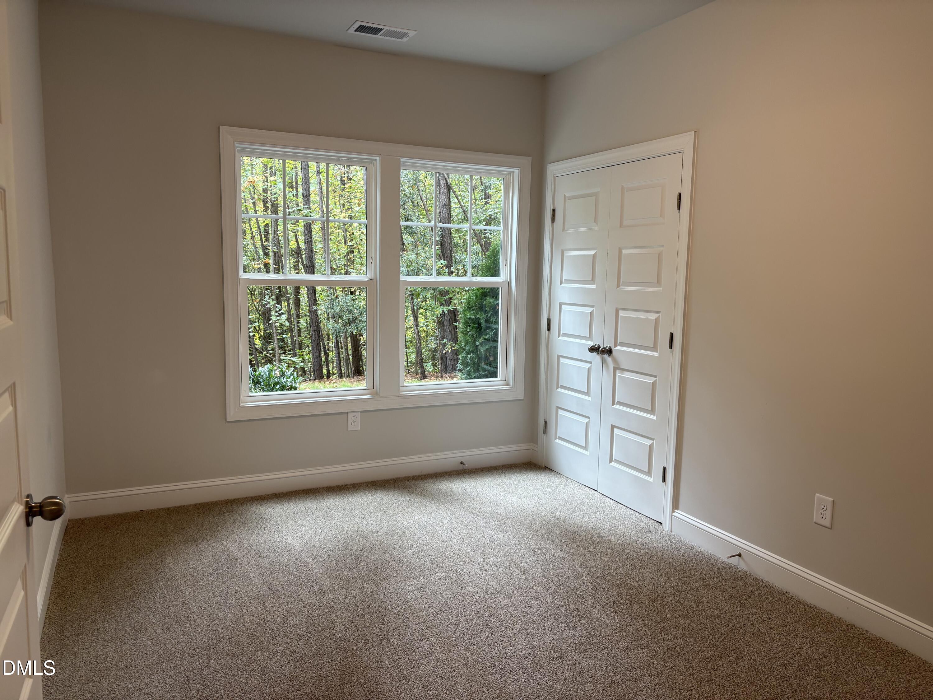 607 Weather Ridge Lane, Unit 24 Cary, NC 27513 - Photo 17 of 26 an empty room with windows and closet