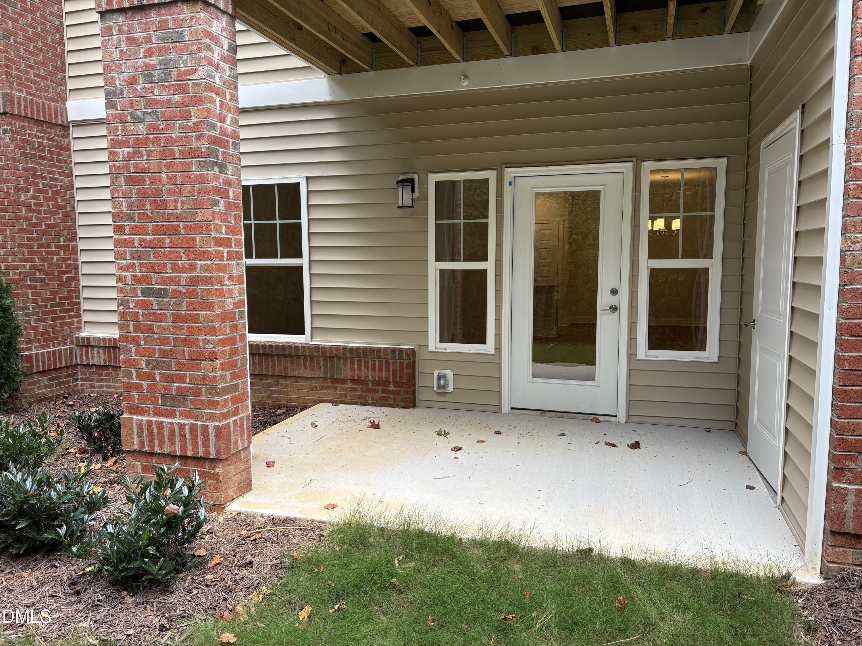 607 Weather Ridge Lane, Unit 24 Cary, NC 27513 - Photo 22 of 26 a view of house with backyard space and porch