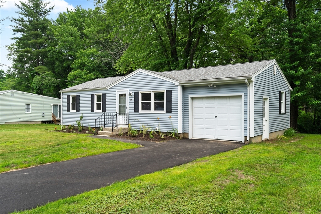 84 Sandy Hill Road Northampton, MA 01062 - Photo 3 of 33 a front view of a house with a garden and yard