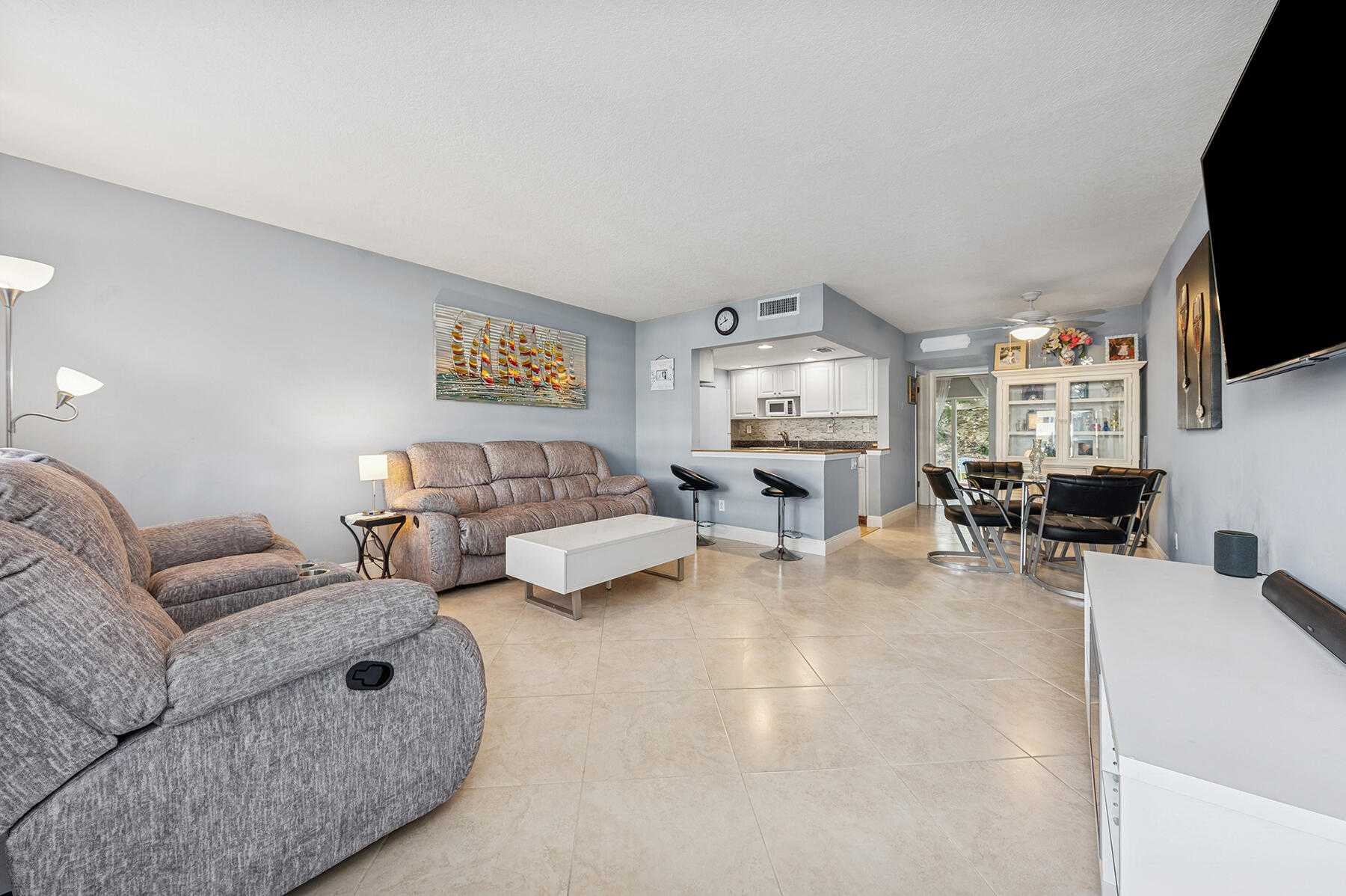 2565 South Ocean Boulevard, Unit 1180 Palm Beach, FL 33480 - Photo 2 of 11 a living room with furniture and a flat screen tv