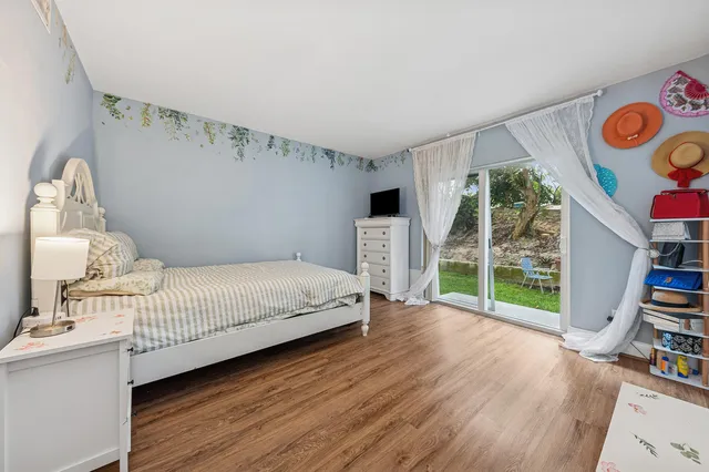 a bedroom with furniture and a book shelf