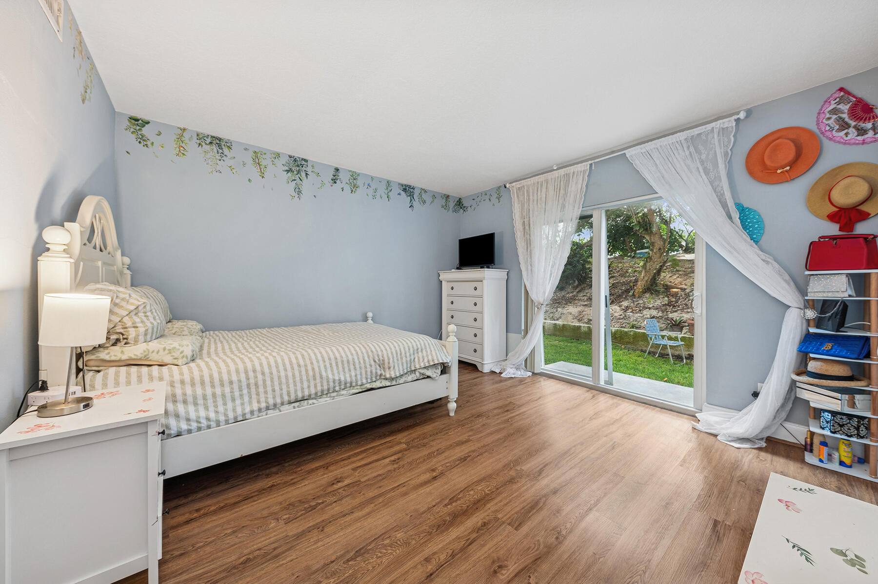 2565 South Ocean Boulevard, Unit 1180 Palm Beach, FL 33480 - Photo 7 of 11 a bedroom with furniture and a book shelf