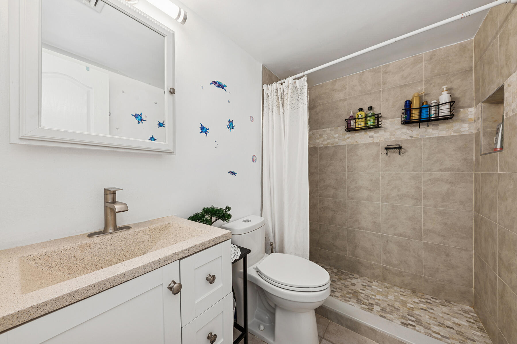 2565 South Ocean Boulevard, Unit 1180 Palm Beach, FL 33480 - Photo 8 of 11 a bathroom with a sink a toilet and shower