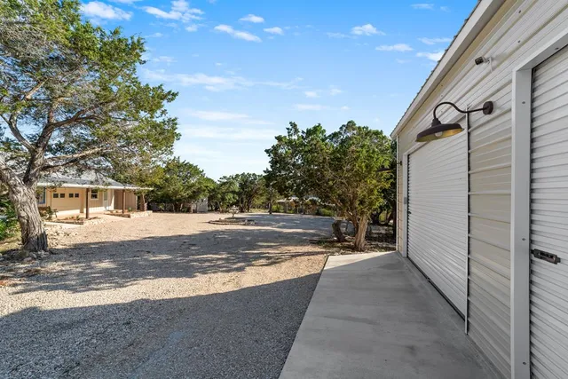 a view of a house with backyard porch and sitting area