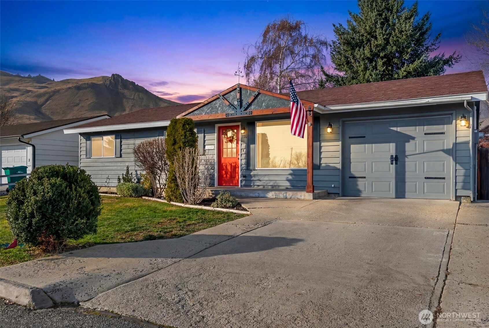 708 Cherry Court Wenatchee, WA 98801 - Photo 26 of 26 a front view of a house with a yard and a garage