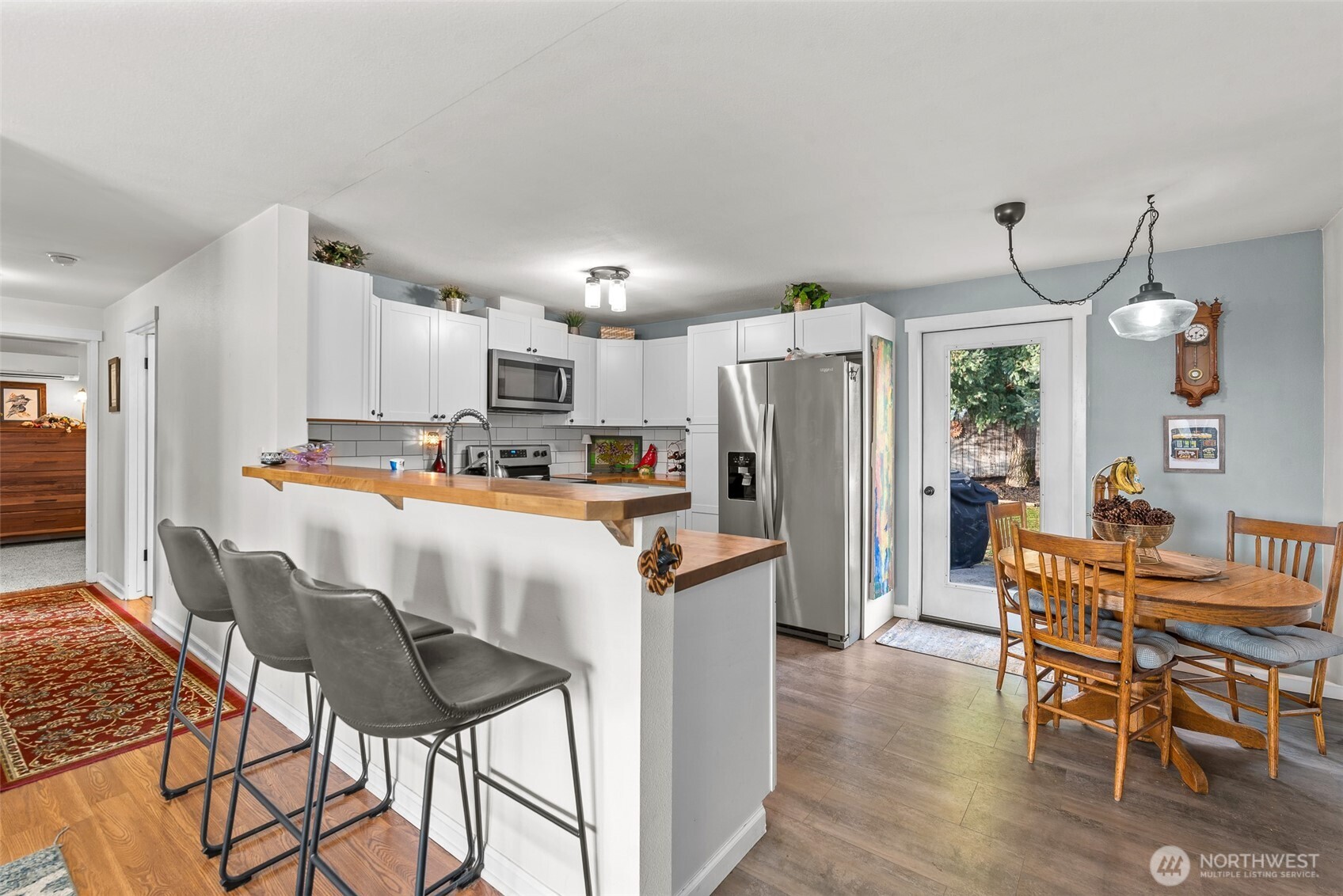 708 Cherry Court Wenatchee, WA 98801 - Photo 7 of 26 a kitchen with stainless steel appliances kitchen island granite countertop a table chairs and a refrigerator