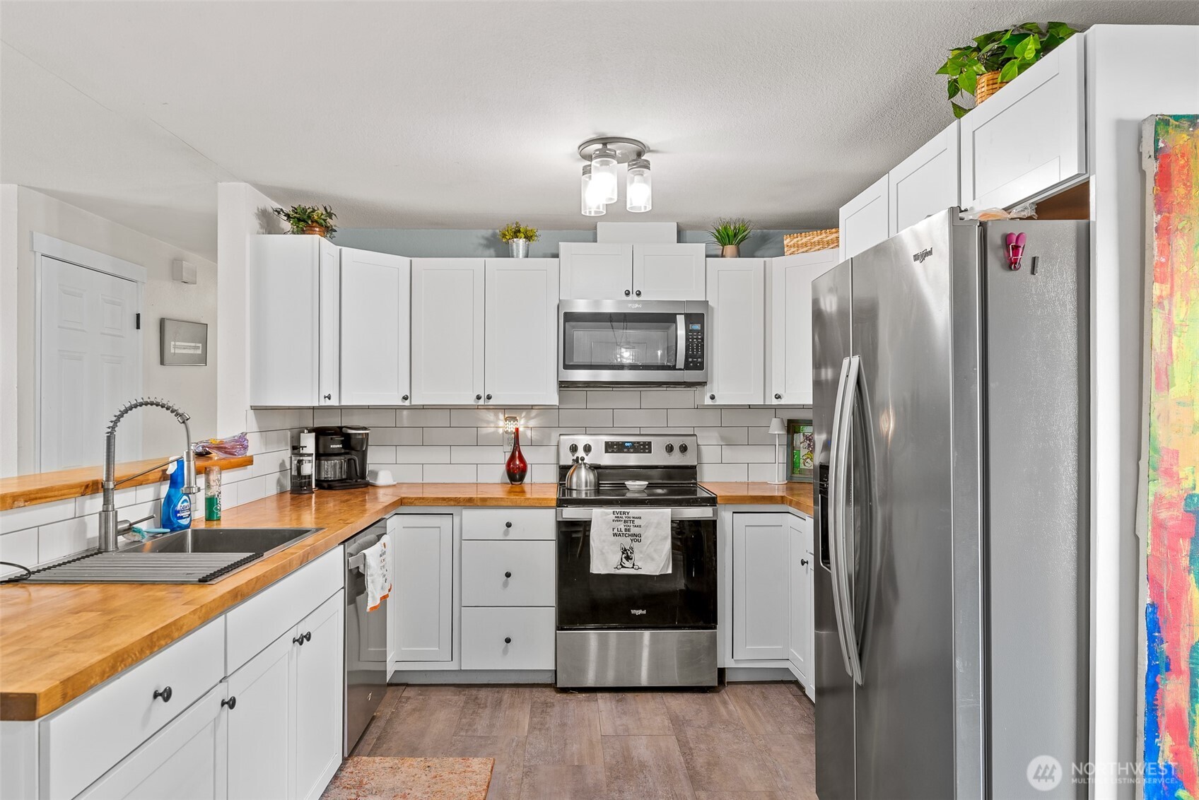 708 Cherry Court Wenatchee, WA 98801 - Photo 9 of 26 a kitchen with stainless steel appliances granite countertop a refrigerator sink and white cabinets