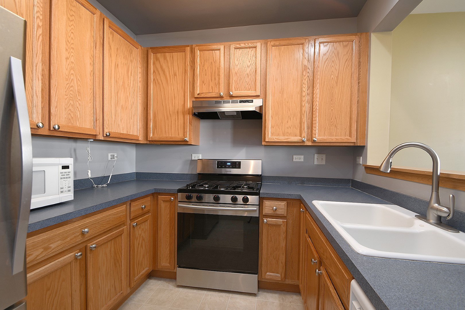 2529 Capitol Avenue Aurora, IL 60503 - Photo 8 of 25 a kitchen with granite countertop a sink a stove and cabinets