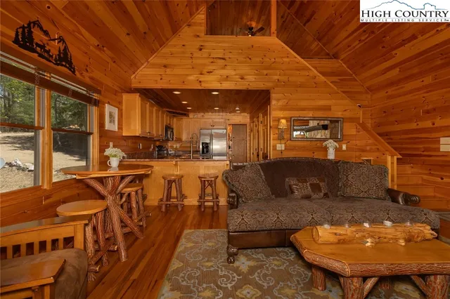a living room with furniture a table and chairs