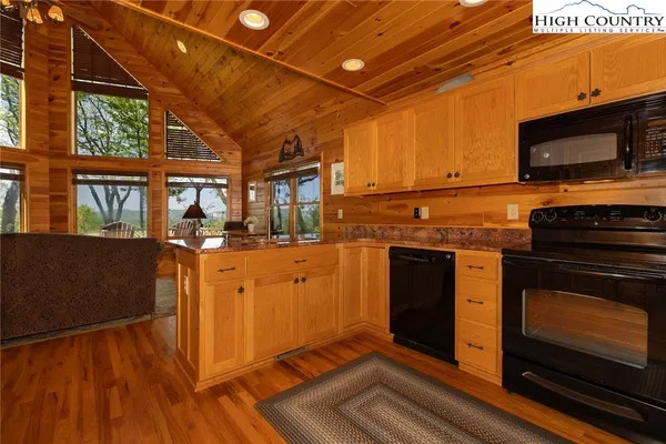 a kitchen with stainless steel appliances granite countertop a stove and a microwave