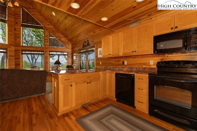 a kitchen with stainless steel appliances granite countertop a stove and a microwave
