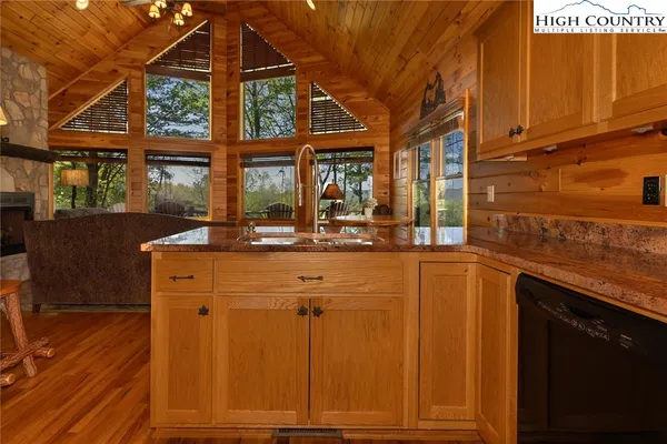 a kitchen with a sink and large windows