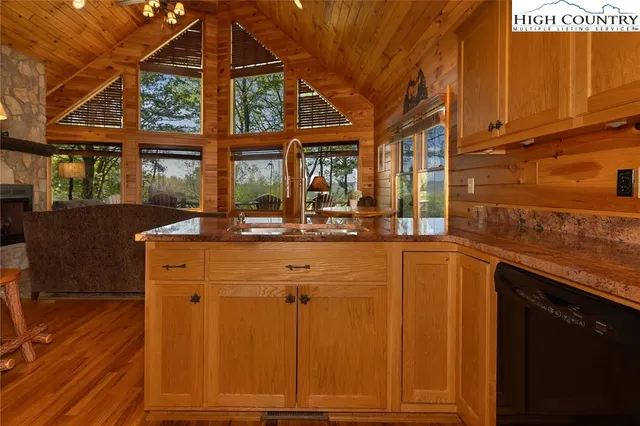 a kitchen with a sink and large windows