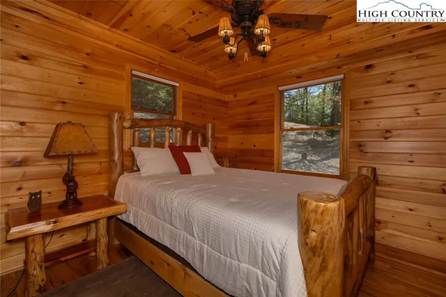 a bed sitting in a bedroom next to a window