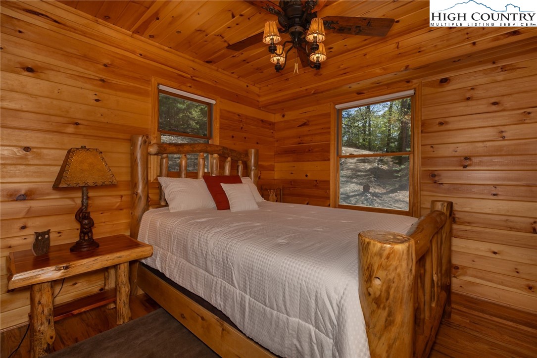 142 Fawn Lane Purlear, NC 28665 - Photo 19 of 49 a bed sitting in a bedroom next to a window