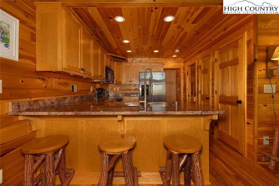 142 Fawn Lane Purlear, NC 28665 - Photo 21 of 49 a view of a dining area with furniture and wooden floor