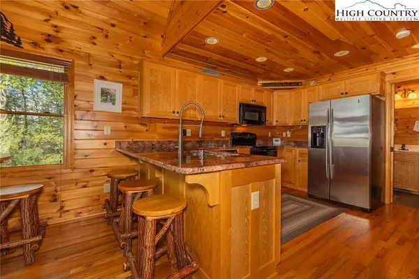 a kitchen with stainless steel appliances wooden cabinets a refrigerator and a stove top oven