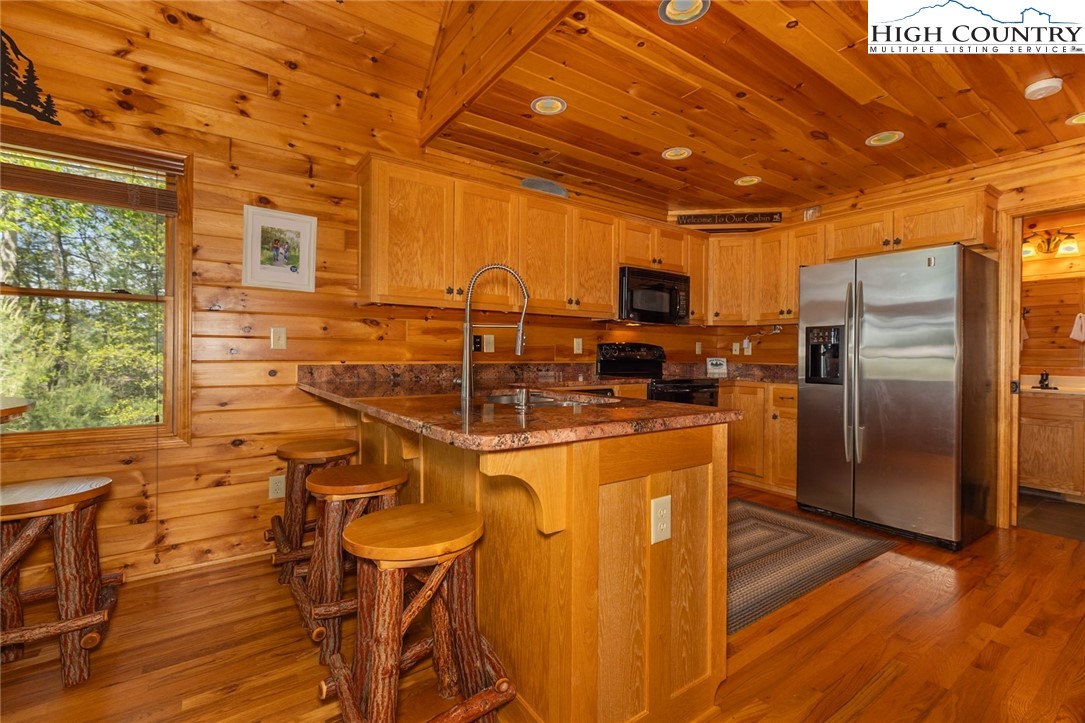 142 Fawn Lane Purlear, NC 28665 - Photo 22 of 49 a kitchen with stainless steel appliances wooden cabinets a refrigerator and a stove top oven