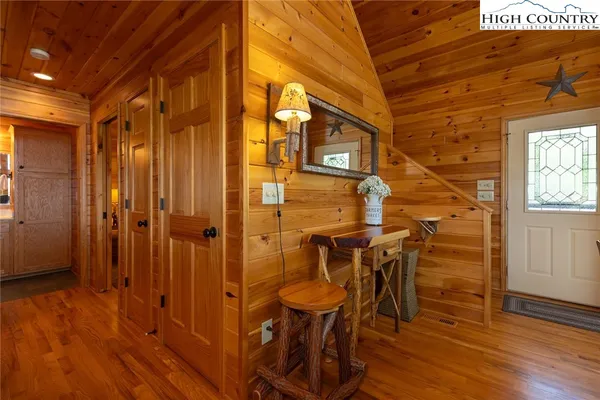 a view of a hallway with wooden floor