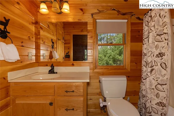 a bathroom with a shower curtain and a bathtub