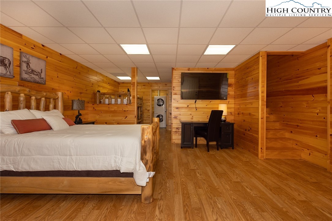 142 Fawn Lane Purlear, NC 28665 - Photo 31 of 49 a bedroom with a bed and a flat screen tv