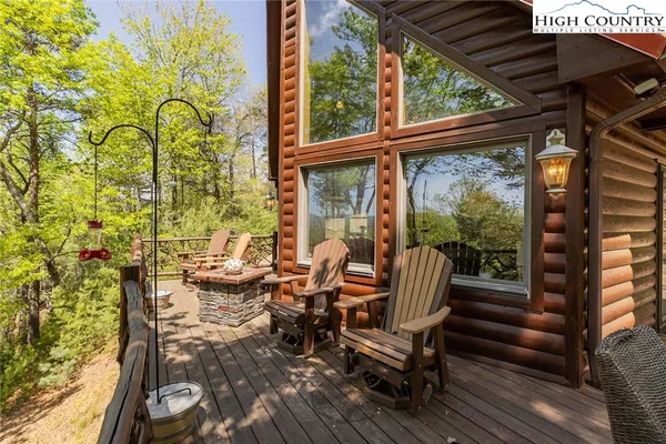a balcony with couple of chairs and a stove