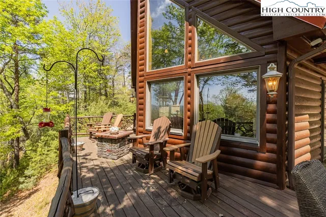 a balcony with couple of chairs and a stove