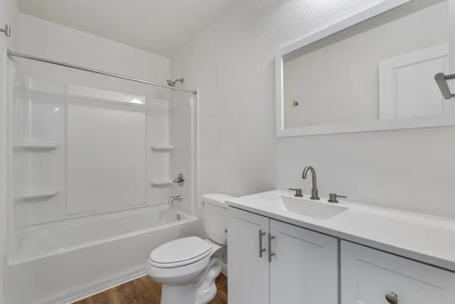 a bathroom with a sink a toilet and a bathtub