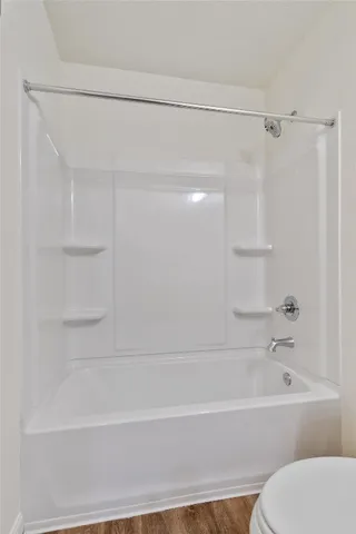 a bathroom with a bathtub and a toilet