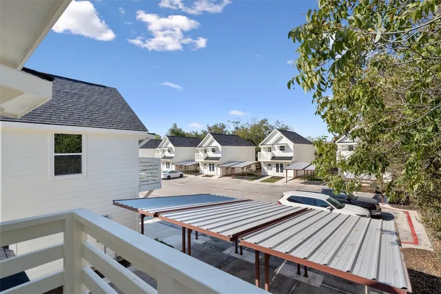 a view of a patio with table and chairs with wooden floor and fence