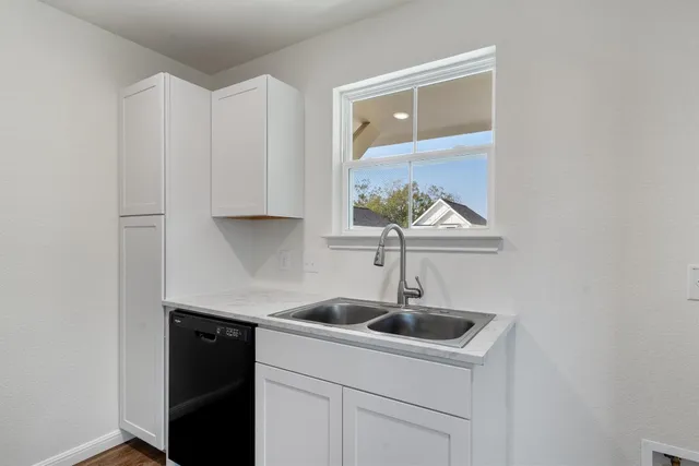 a kitchen with a sink and cabinets