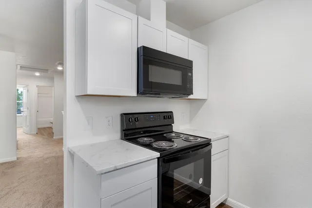 a kitchen with a stove and a microwave