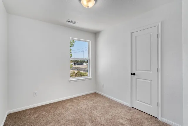 an empty room with windows and closet